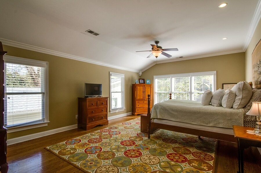 Upstairs, the master bedroom has a tremendous amount of natural light, and the beautiful hardwoods and custom trim continue throughout.