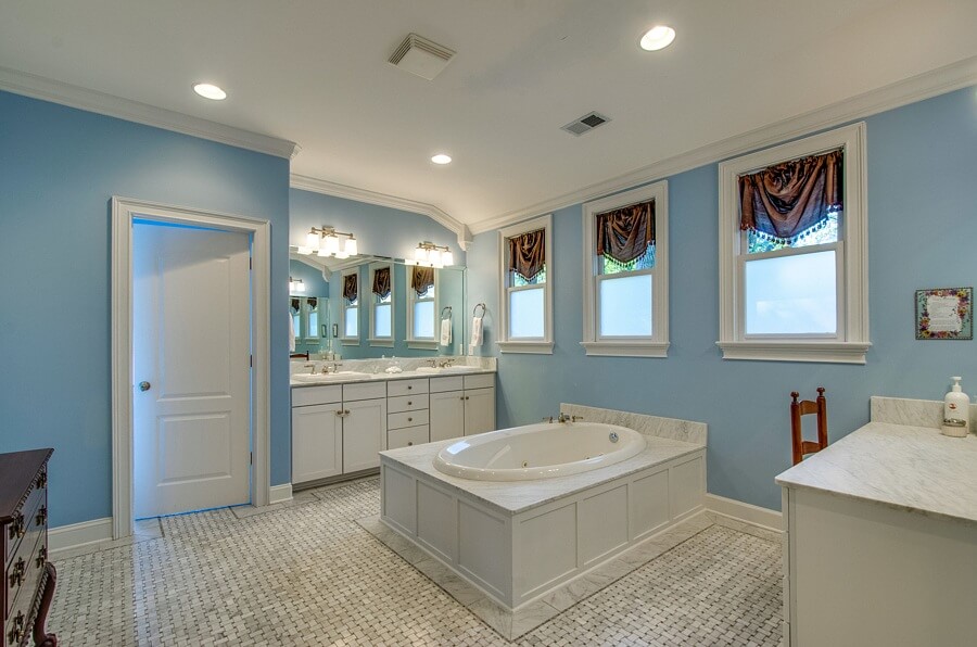 The master bath features dual vanities, a soaking tub, a separate shower, and a walk-in closet with vanity