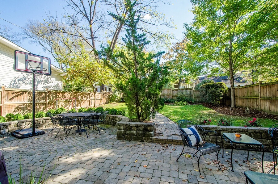 In addition to the welcoming front porch, the backyard boasts a lovely patio area perfect for outdoor dining and entertaining. And with secure fencing and beautiful landscaping, it's an area that's perfect for lounging nearly all year long!