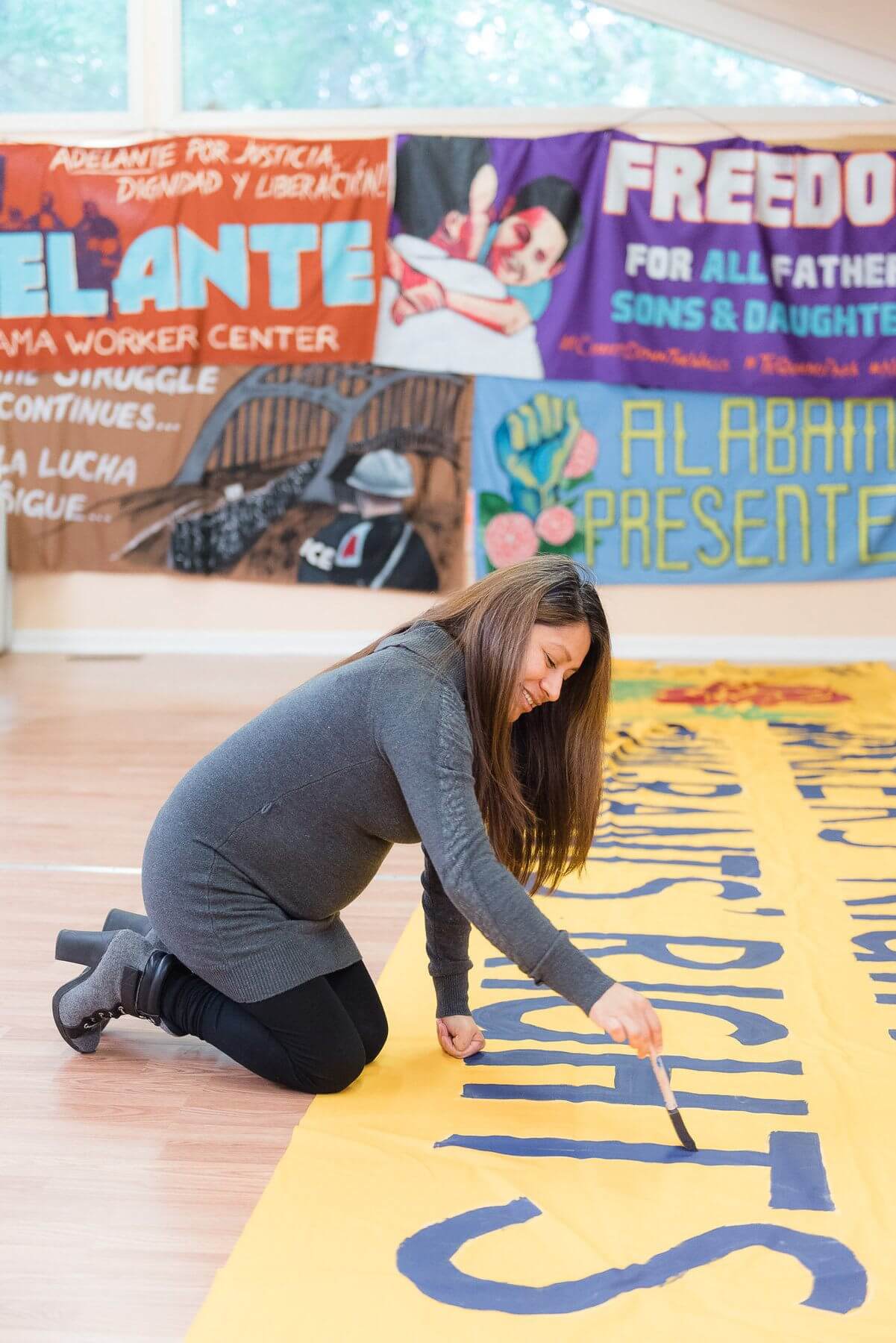 The Adelante Alabama Worker Center is filled with colorful signs promoting awareness of social justice issues. The Adelante Alabama Worker Center is filled with colorful signs promoting awareness of social justice issues.