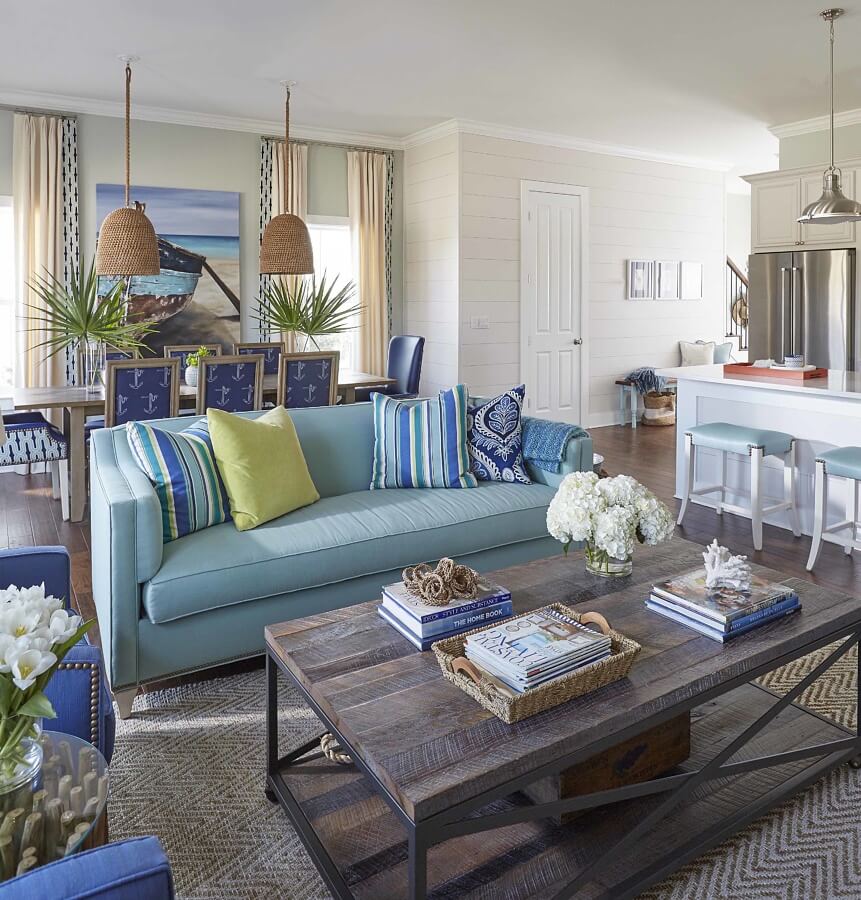 A sofa and chairs from the designer’s own furniture line add color to the living room. The designer created a handy coffee table by adding reclaimed wood and casters to a metal frame; the table can be rolled to the side if someone wants to use the sleeper sofa.