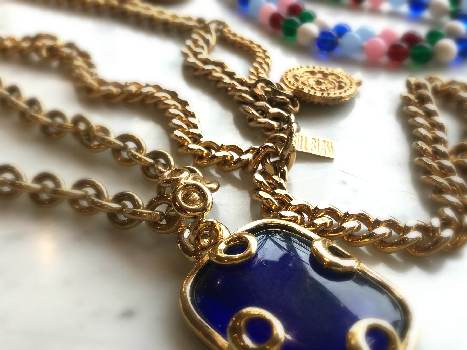 Gems from the 80s: a Givenchy lapis blue pendant necklace + Bill Blass coin accent multi-strand chain belt. Gems from the 80s: a Givenchy lapis blue pendant necklace + Bill Blass coin accent multi-strand chain belt.