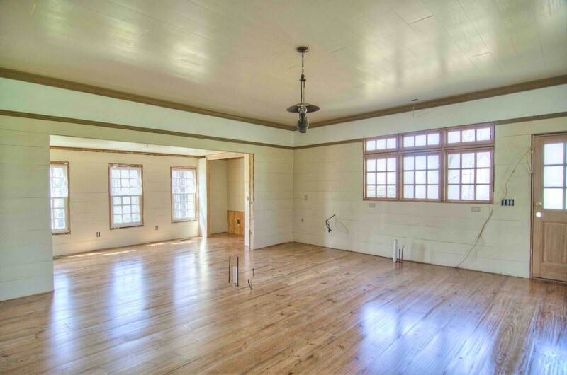 This expansive room is ideally where a kitchen could be finished out — you can see where it has been plumbed and also offers electrical.