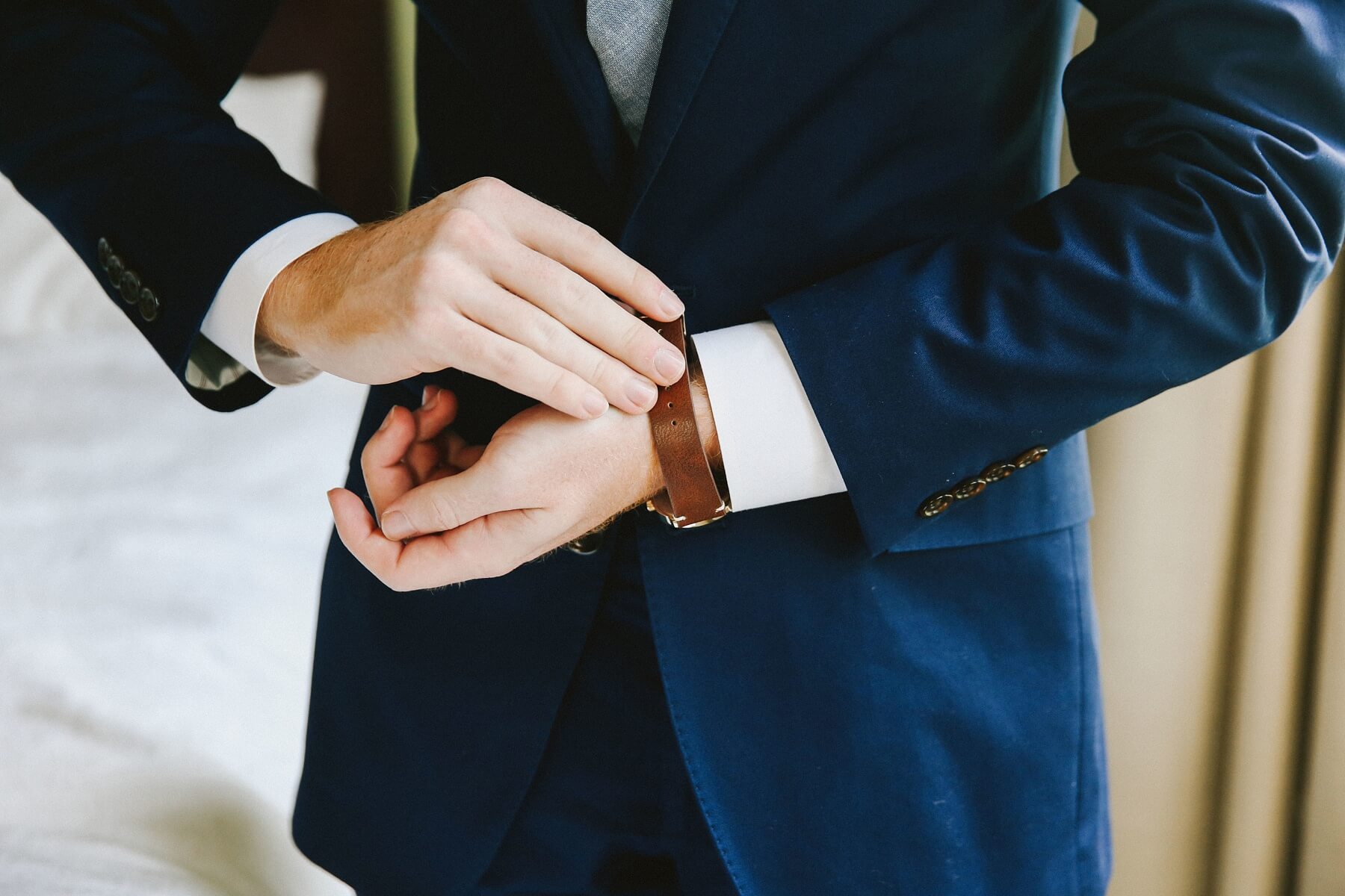 Adam buckles a leather watch that Natalie gave him as a pre-ceremony gift, the perfect finishing touch to his dapper duds!