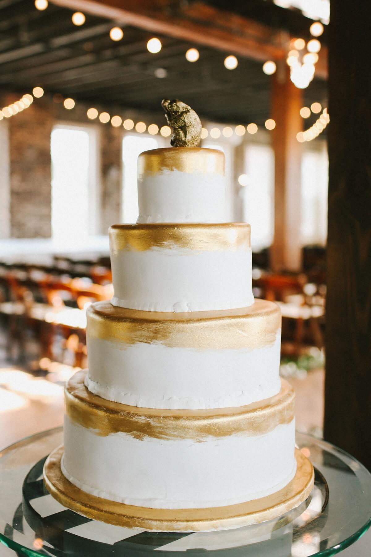 This classic four-tiered yellow wedding cake with gold accents had a whimsical twist. The bride and groom ordered figurines of their favorite animals—Natalie’s favorite is the sloth while Adam’s is the orangutan—and painted them gold with plans to position the figurines atop the cake as the topper. The finished result was absolutely adorable! “A lot of people told us not to do it, but we knew it was what we wanted and we loved the final result,” Natalie says.