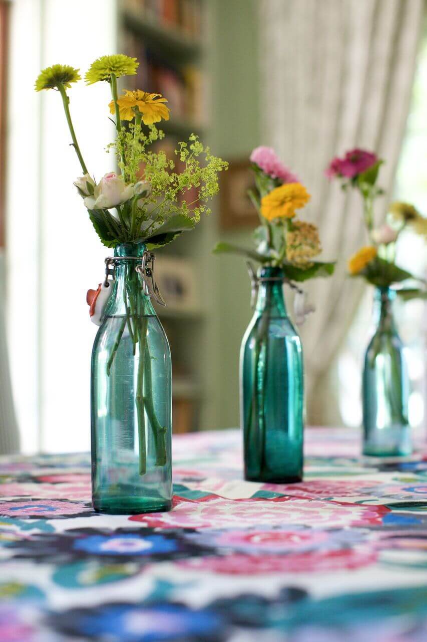 Recycled bottles are ideal for making smaller arrangements look full and complete. Image: Arden Ward