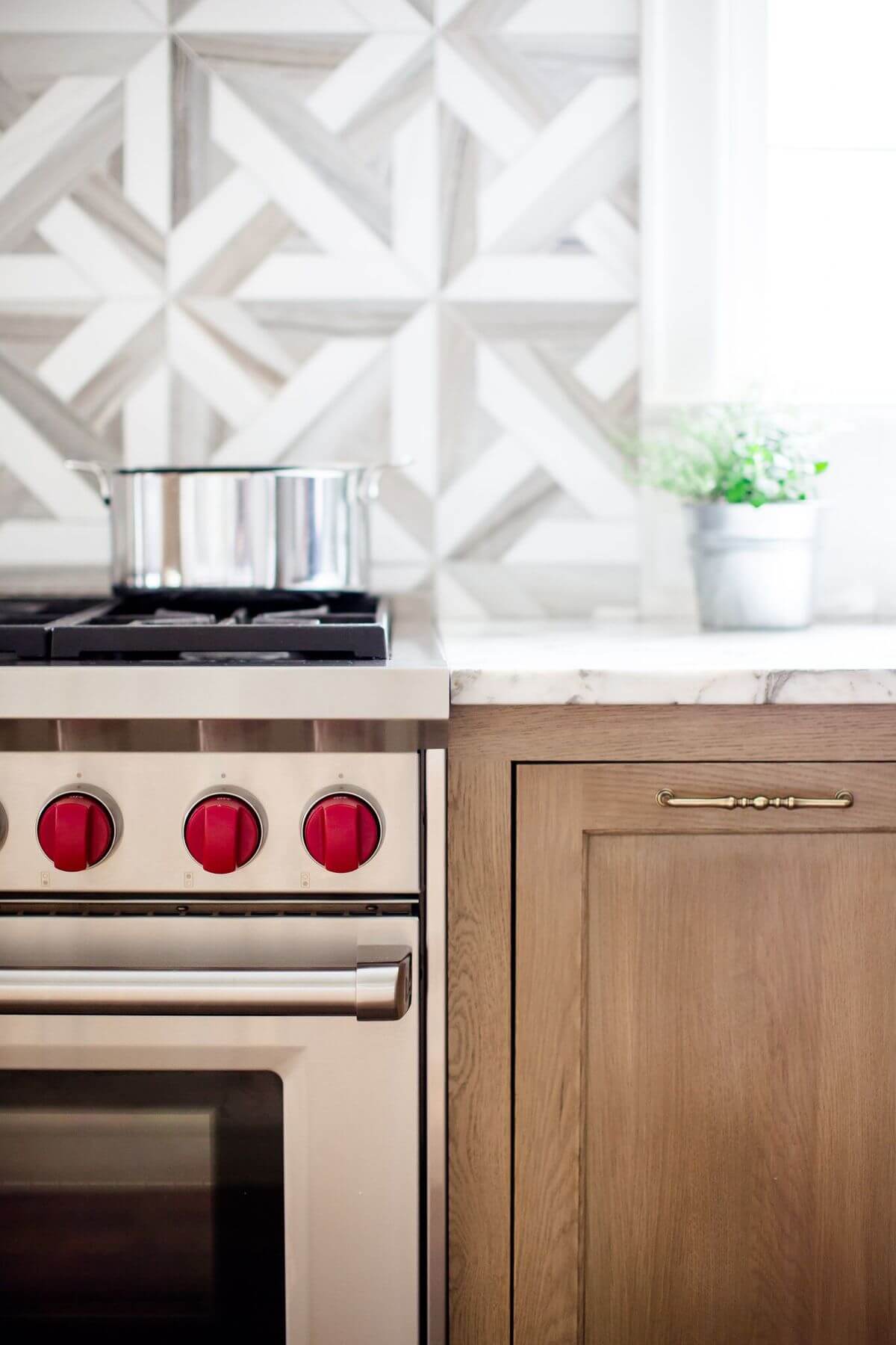 "I love the details of this kitchen — the limed oak cabinets, Wolf range, marble countertops and the beautiful marble mosaic backsplash." says Marianne. Image: Holland Williams
