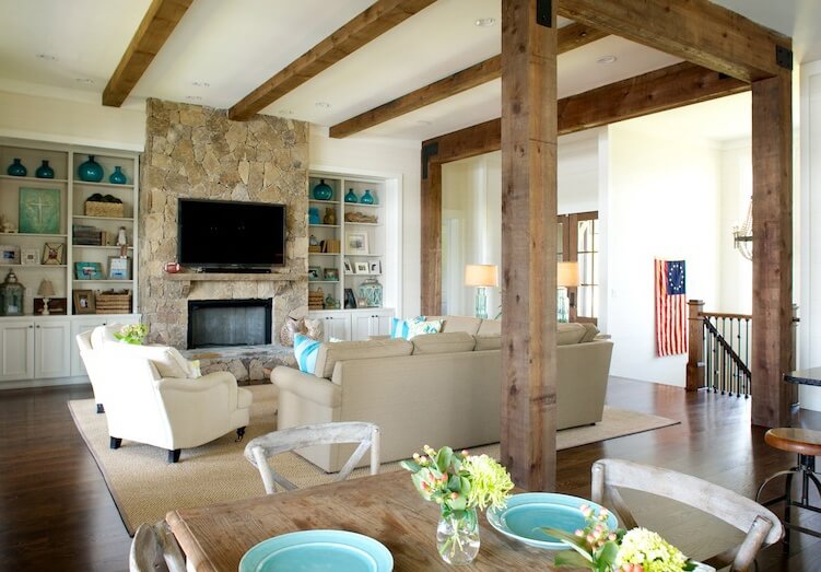 "I really love how open it is," says Marianne of this Lake Martin home's living space. "I love the beams, the stone on the fireplace and it can seat a lot of people, but it’s very cozy." Image: Beth Hontzas