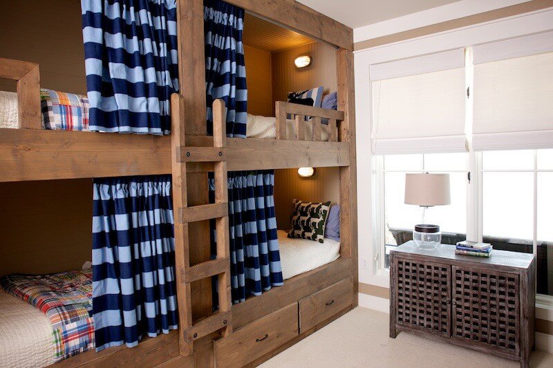 "I love the striped curtains and the warm wood," says Marianne of this bunk room at Lake Martin. "It feels like what a lake house bunk room should feel like." Image: Beth Hontzas