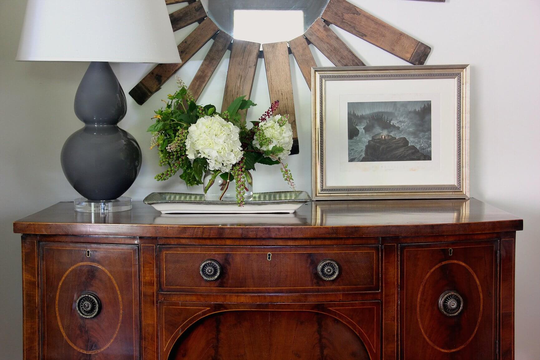 "I love the blend of a very traditional antique server and a somewhat modern lamp, along with the mirror made of an antique wine barrel," says Marianne. "I like that this shows how you can mix different elements." Image: Marianne Strong