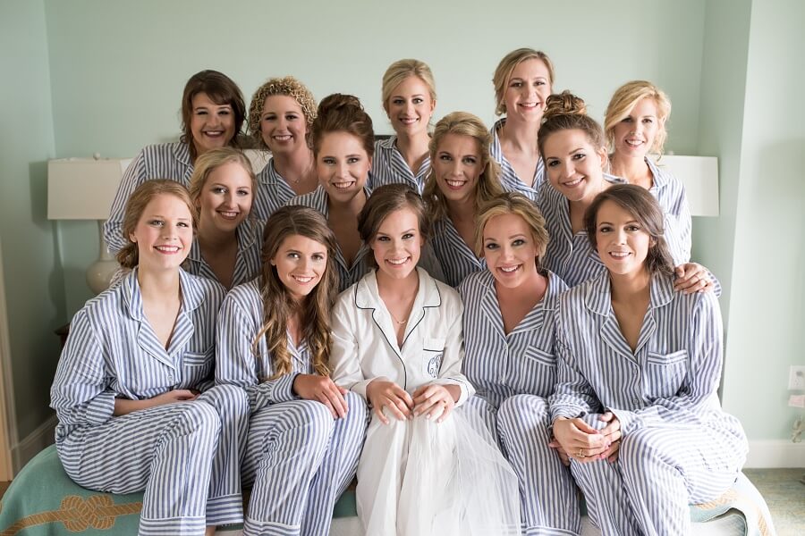 Donning matching pjs, the bridesmaids pose for a picture before changing into their wedding attire.
