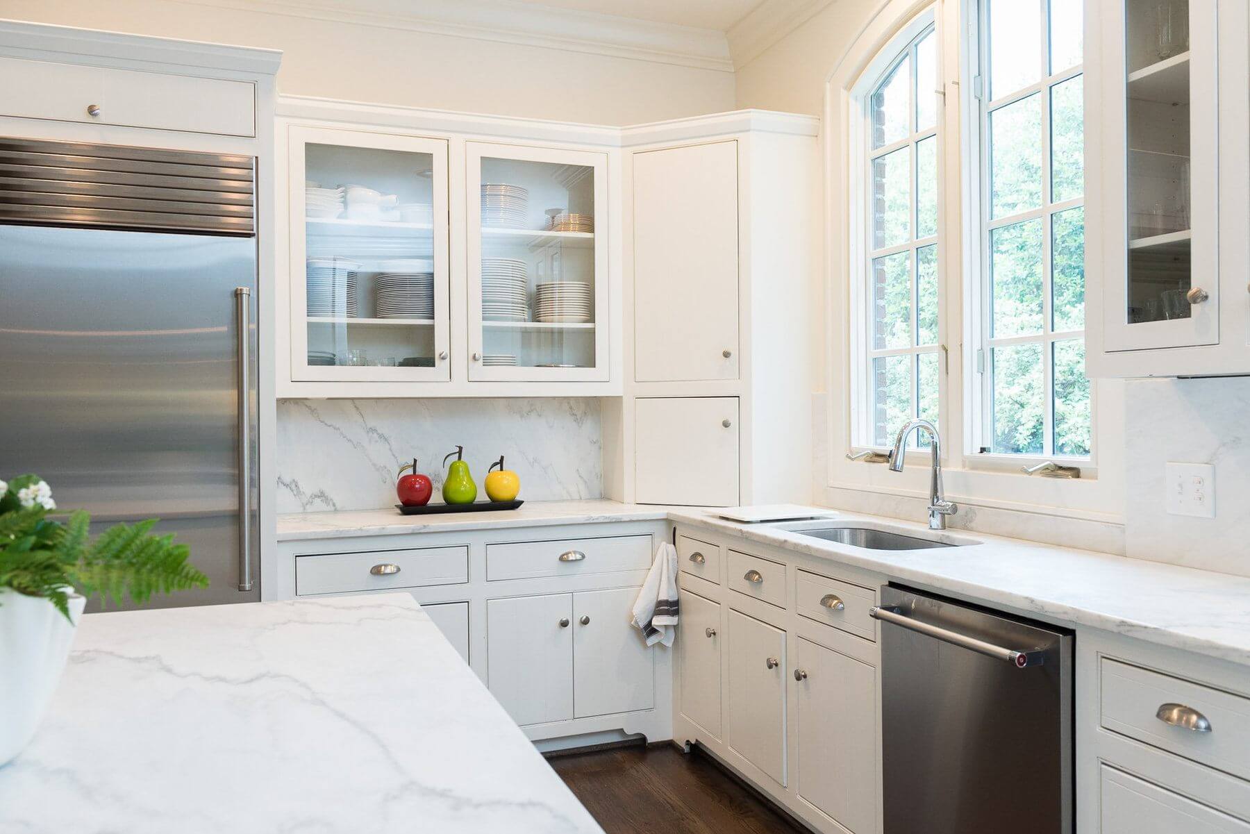 The clear glass cabinets, large windows and gorgeous white counter tops make for an airy, white, inviting space. The clear glass cabinets, large windows and gorgeous white counter tops make for an airy, white, inviting space.