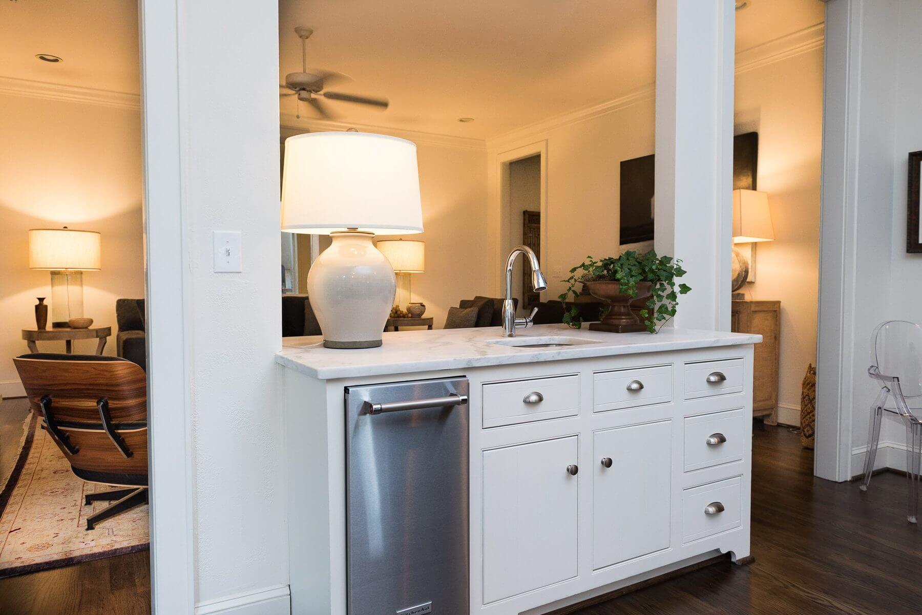 "One of our favorite things about the house is removing the built-in cabinet over the island between the kitchen and den. This made for a much more open and larger space," says Sean. "And it made the kitchen much more functional for entertaining family and friends." "One of our favorite things about the house is removing the built-in cabinet over the island between the kitchen and den. This made for a much more open and larger space," says Sean. "And it made the kitchen much more functional for entertaining family and friends."