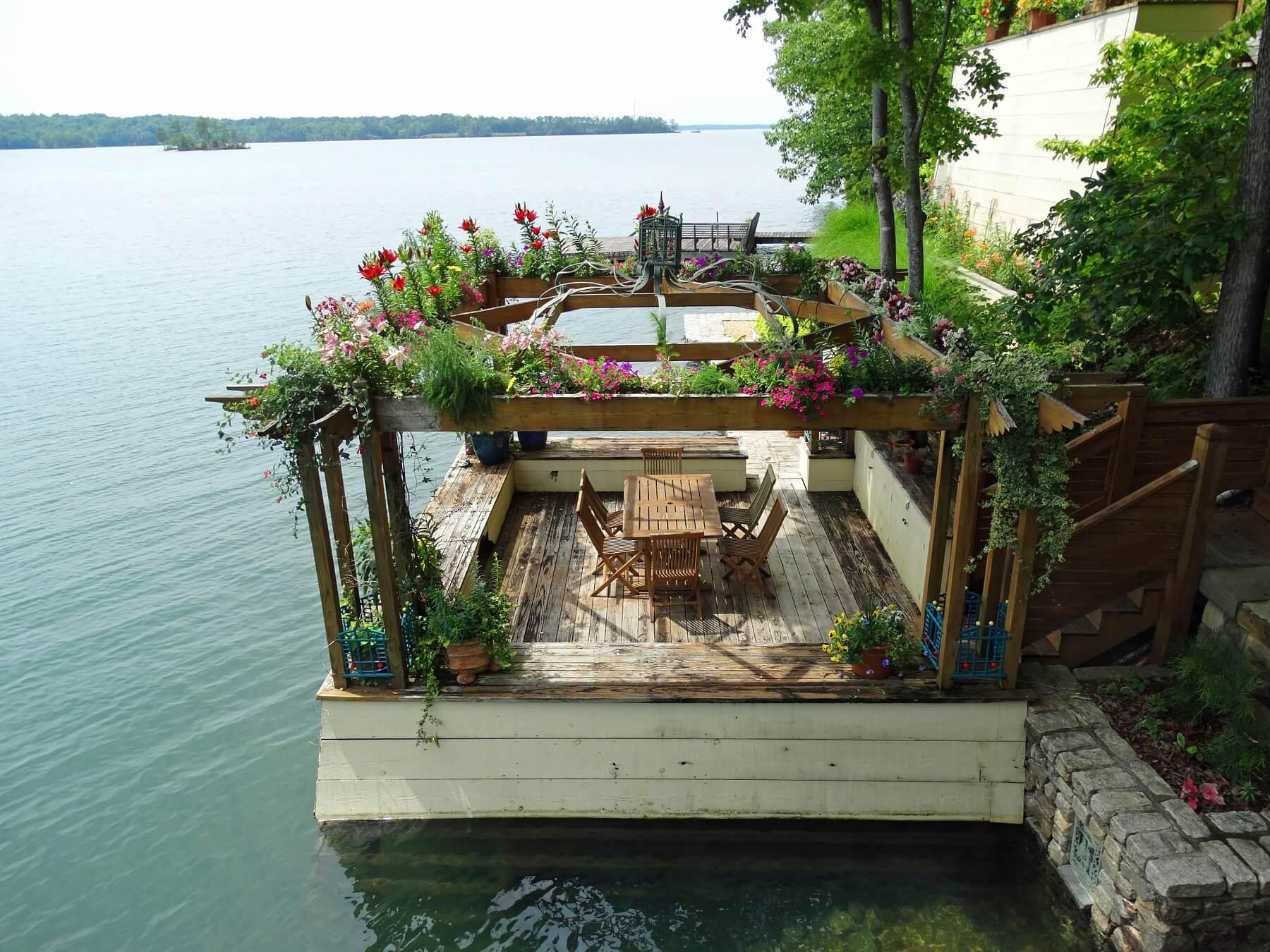 A beautiful lakeside gazebo features a gorgeous canopy of flowers. 