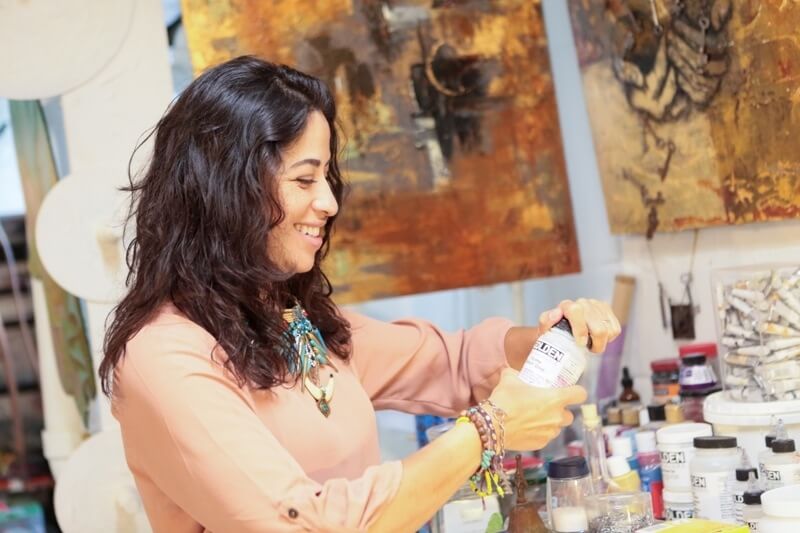 Yancy smiles in her happy place, her studio.