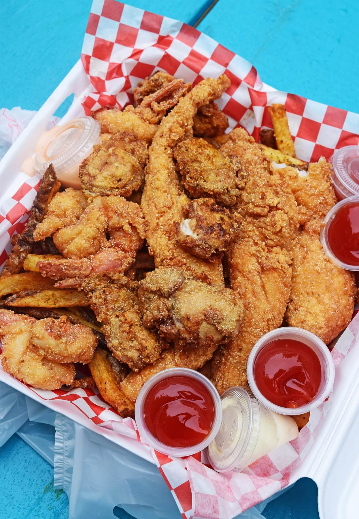 The Captain's Platter from Fresh Gulf Shrimp includes catfish fillets, Gulf shrimp, oysters, and fresh cut seasoned fries. 