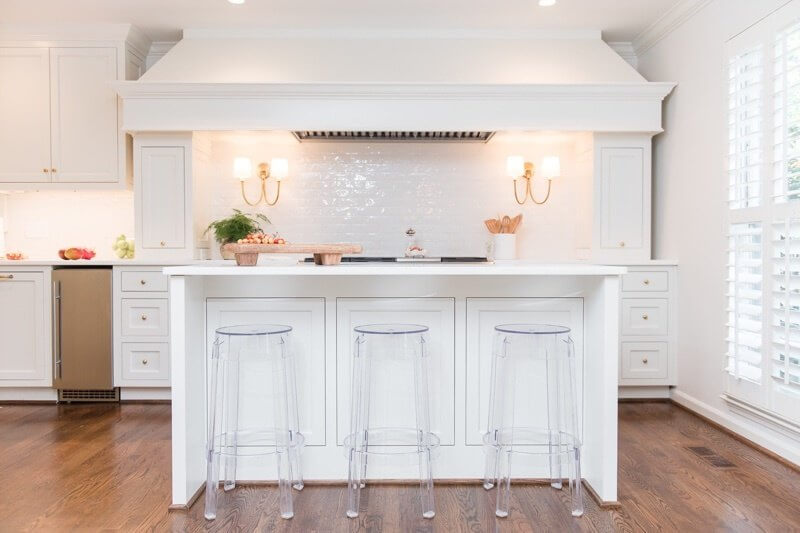 After: What was once the far wall of the dining room space now houses the heart of the kitchen. The new white kitchen is simply stunning.