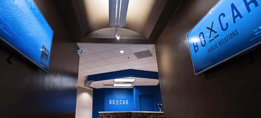 The hallway leading to the lobby is lined with screens showcases slideshows of the agency's projects and clients. Image: Boxcar PR