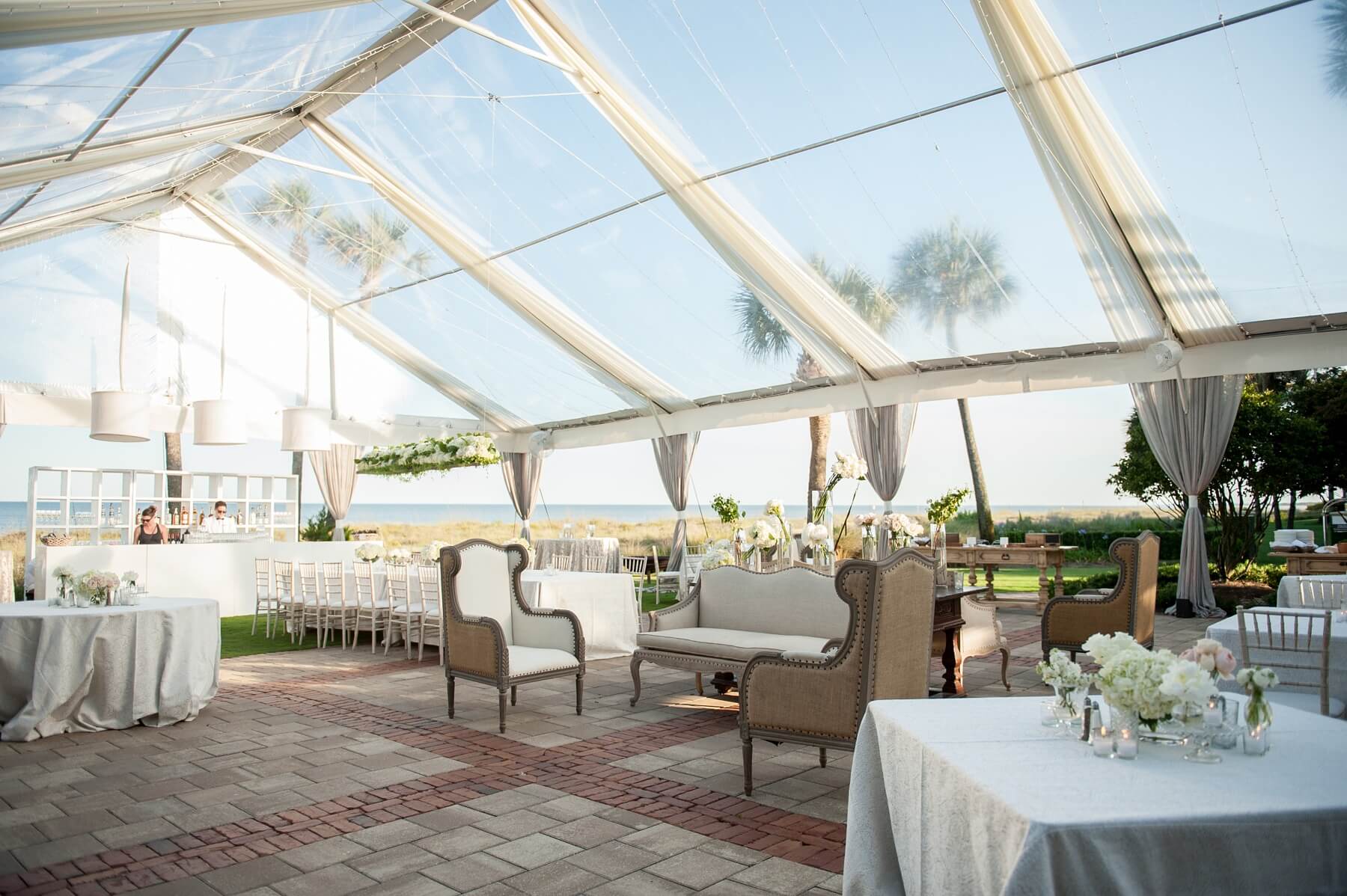 The gorgeous coastal view was a high priority for Holly and Ryan, so they had a clear tent constructed to maximize the stunning scenery.