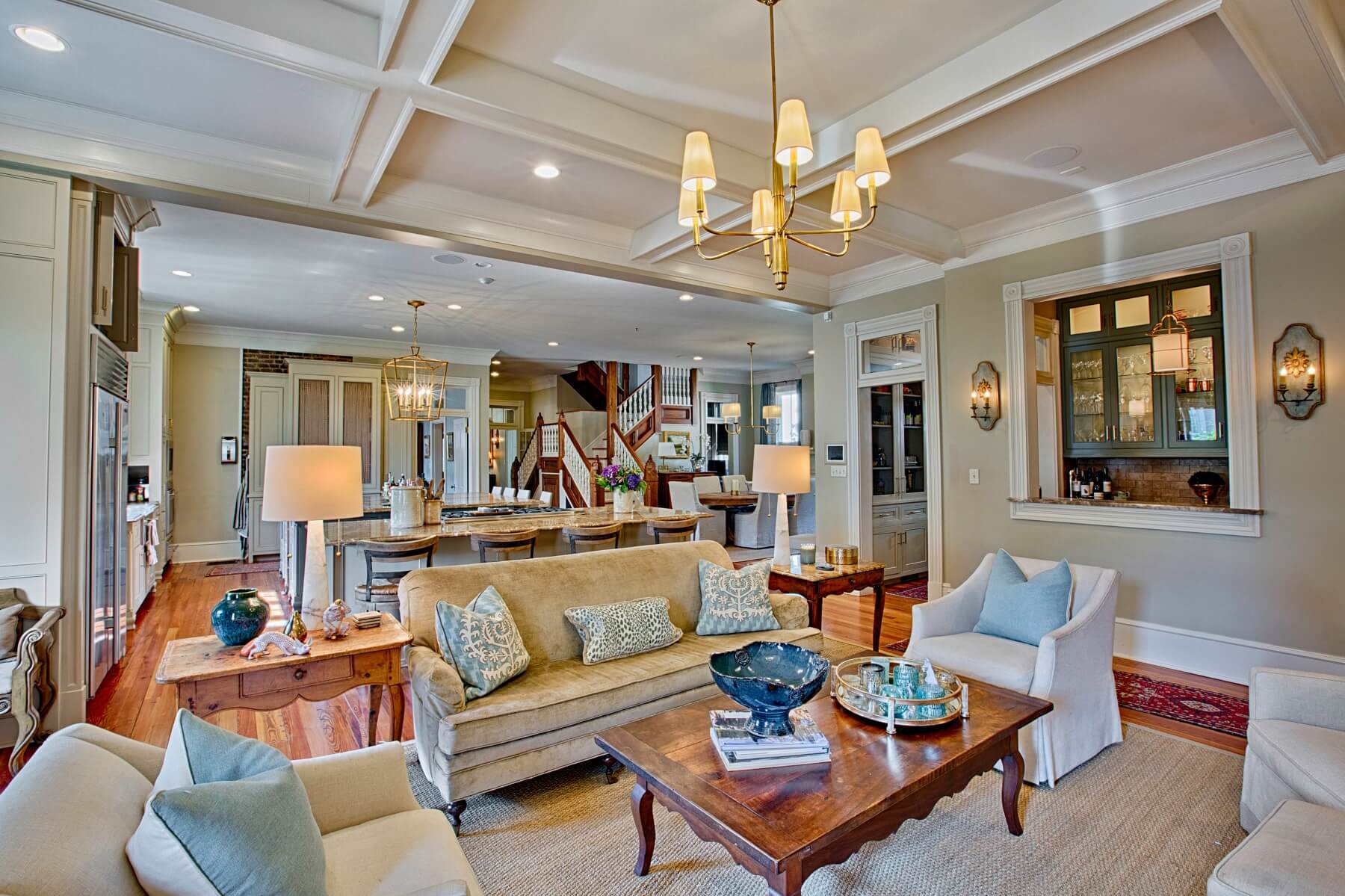 After: This view offers a glimpse into just how open the space becomes with removal of the wall — living room flows into kitchen, which flows into dining room adjacent to the home's central staircase.