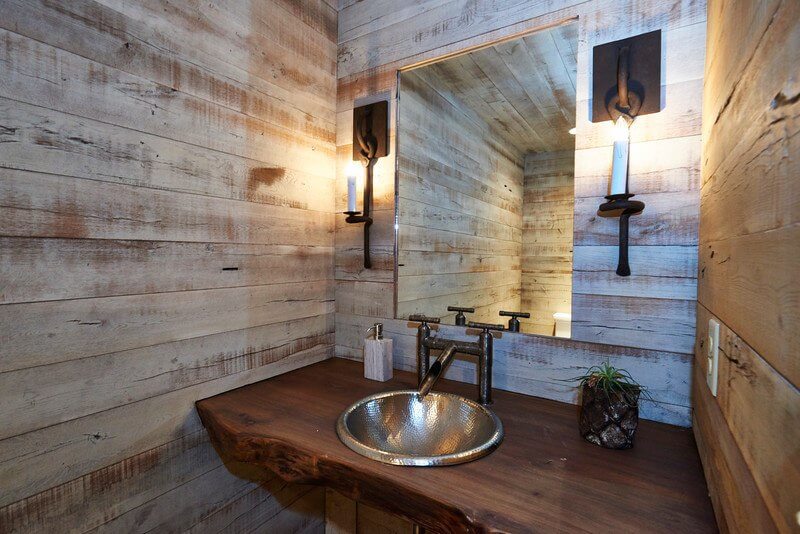 After: By closing off a full bathroom, a new powder bath — as well as an entire full bathroom on the other side — was created. Since the plumbing was in place, it was less costly and it allowed one bathroom for guests and another for the private suite.