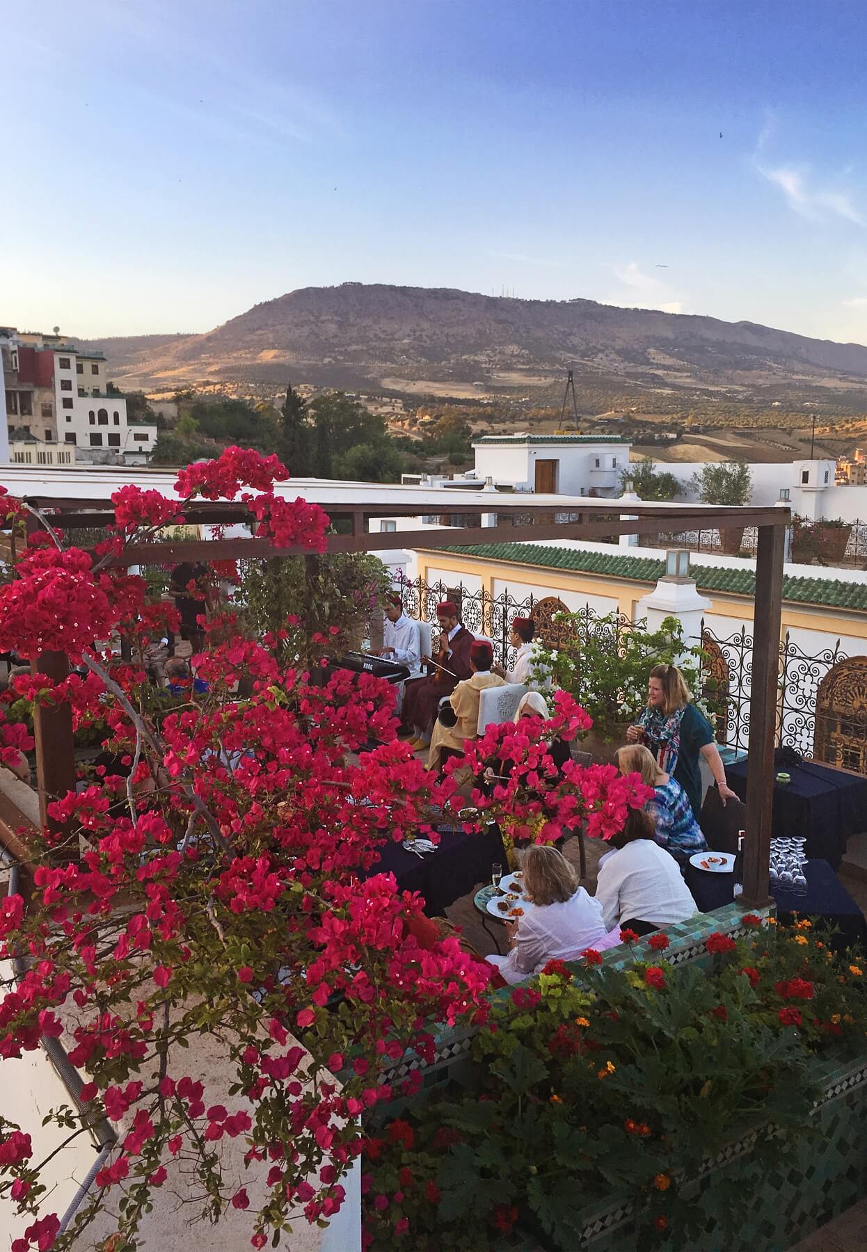 The tour group enjoys an afternoon celebration with champagne and live Moroccan music atop the Palais Amani.