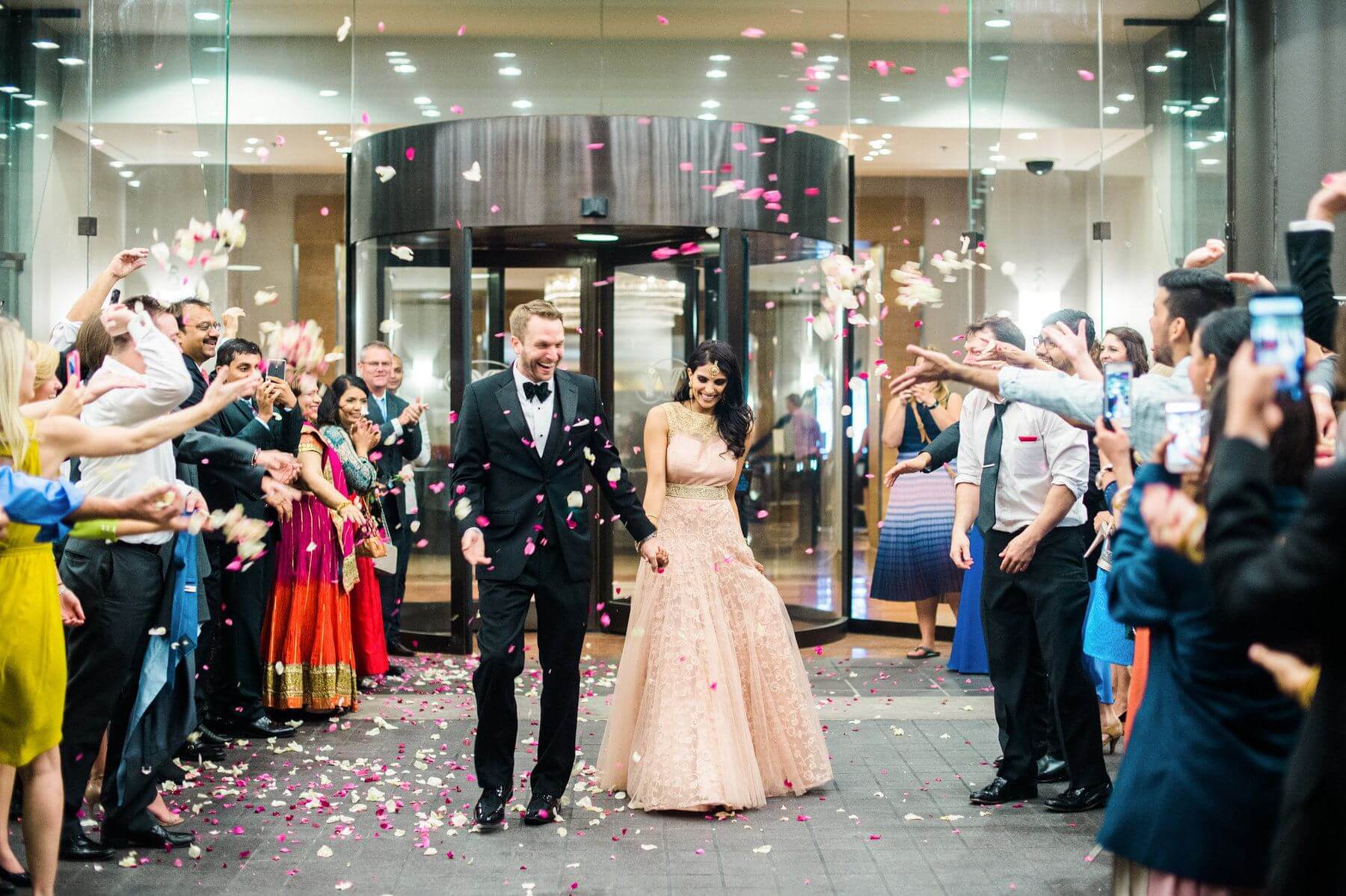 The happy couple exits under a shower of beautiful rose petals! The happy couple exits under a shower of beautiful rose petals!