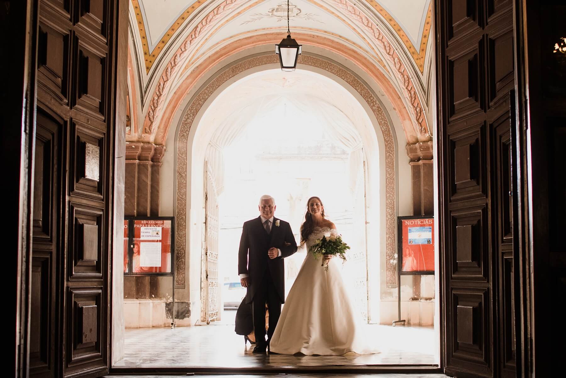 Sarah Kate and her father prepare to walk down the long aisle at Iglesia y Basilica de San Francisco. Argentina Wedding