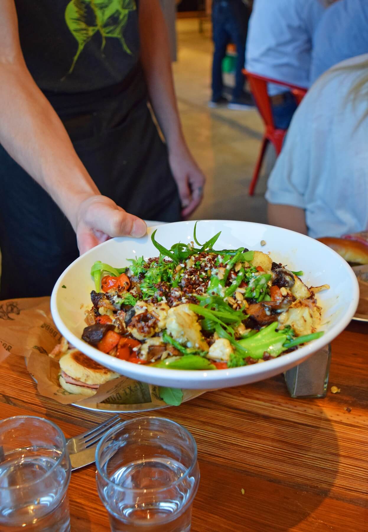 The Next Door roasted veggie bowl is one of their most popular items. Roasted veggies are tossed with quinoa, sunflower seeds and a tasty cilantro tahini dressing. Next Door