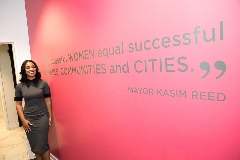 Theia stand beside a quote by Mayor Kasim Reed: "Successful women equal successful families, communities and cities." We couldn't have said it better ourselves! Theia Smith