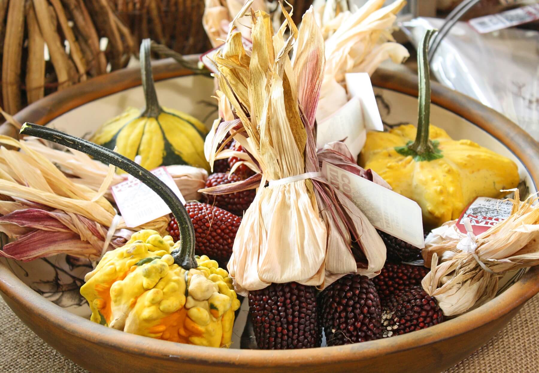A bowl of tiny gourds and Indian corn makes a chic, long-lasting centerpiece.