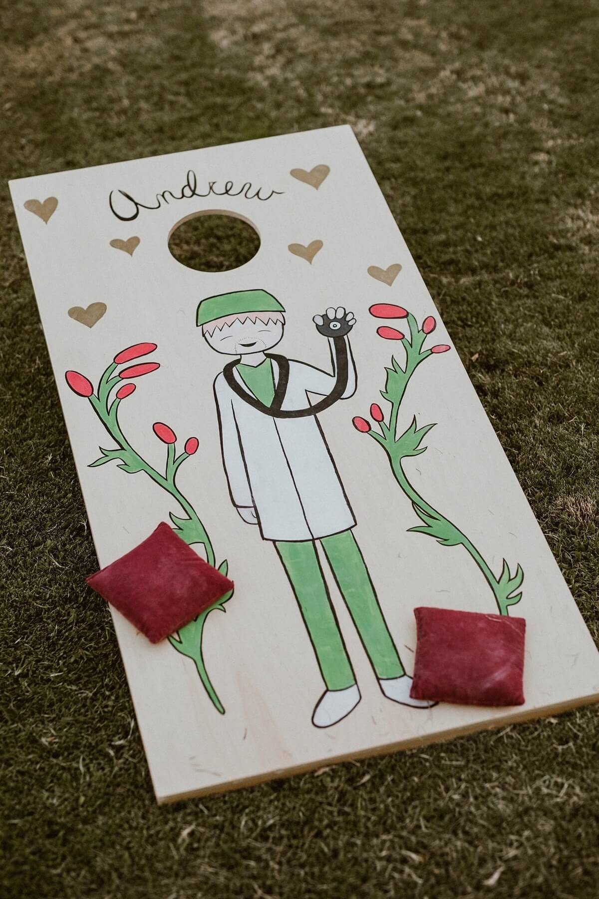 The reception featured a cornhole game, personalized with cartoon renderings of Martha and Andrew.