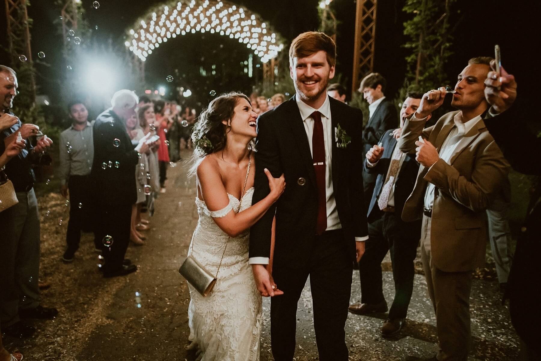 The newlyweds head off toward their new life together under a cascade of bubbles!