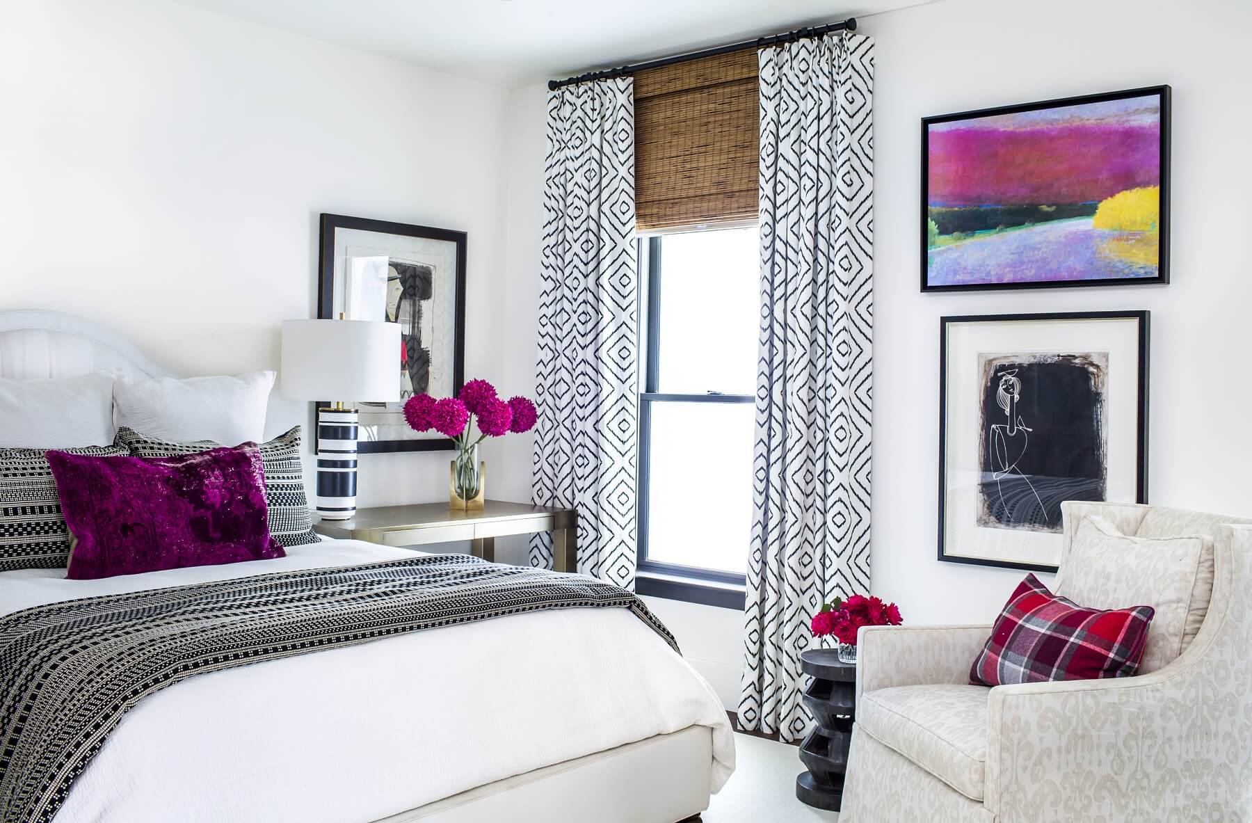 This guest bedroom has a crisp black-and-white theme with touches of pink. Katespade.com lamps and bedding from westelm.com and crateandbarrel.com add a modern flair.