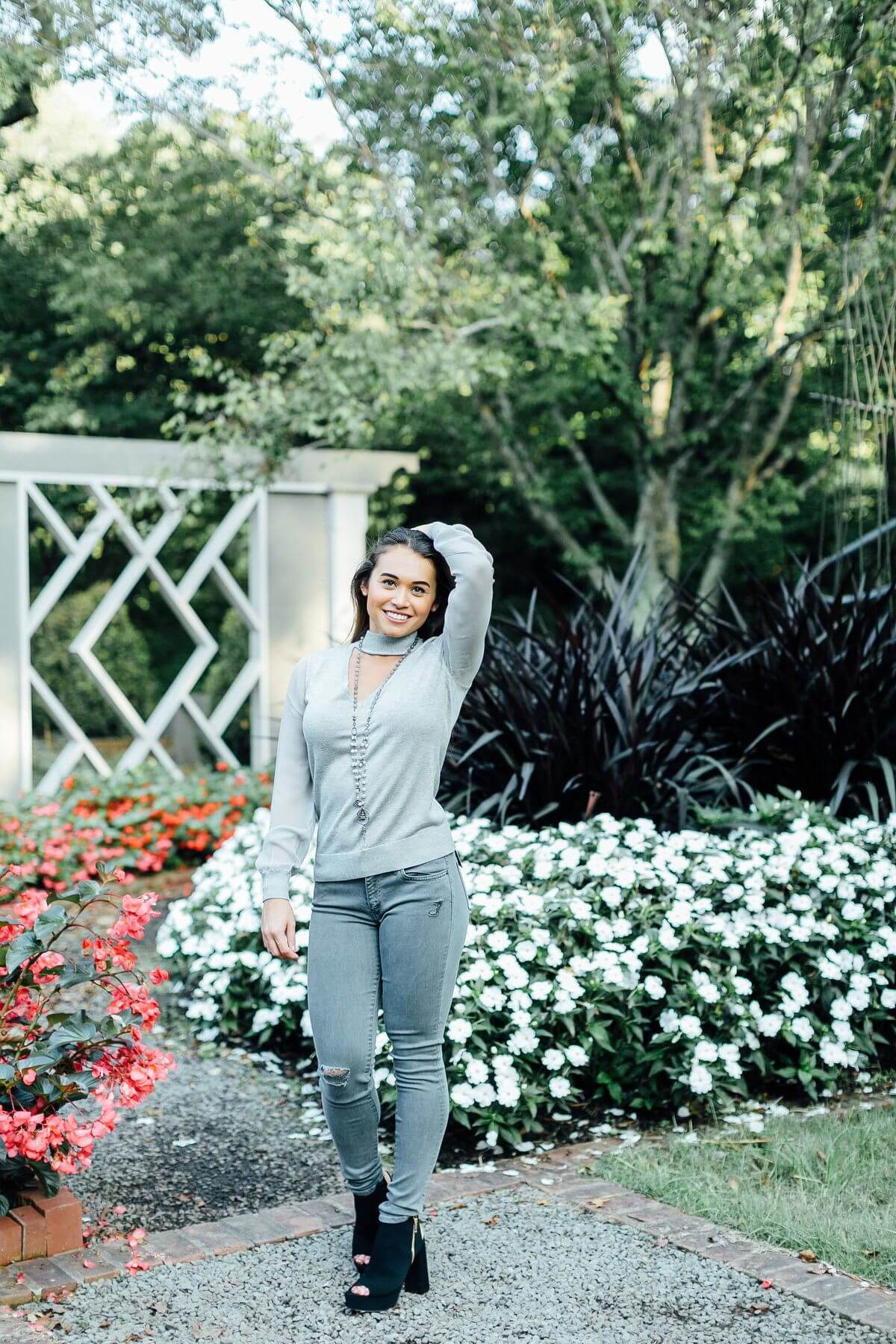 On Christi, from Lori James Contemporary Boutique: Ramy Brook sheer sleeve choker sweater, $345; Principle gray skinny jean, $128; Braided grey agate gems, $345