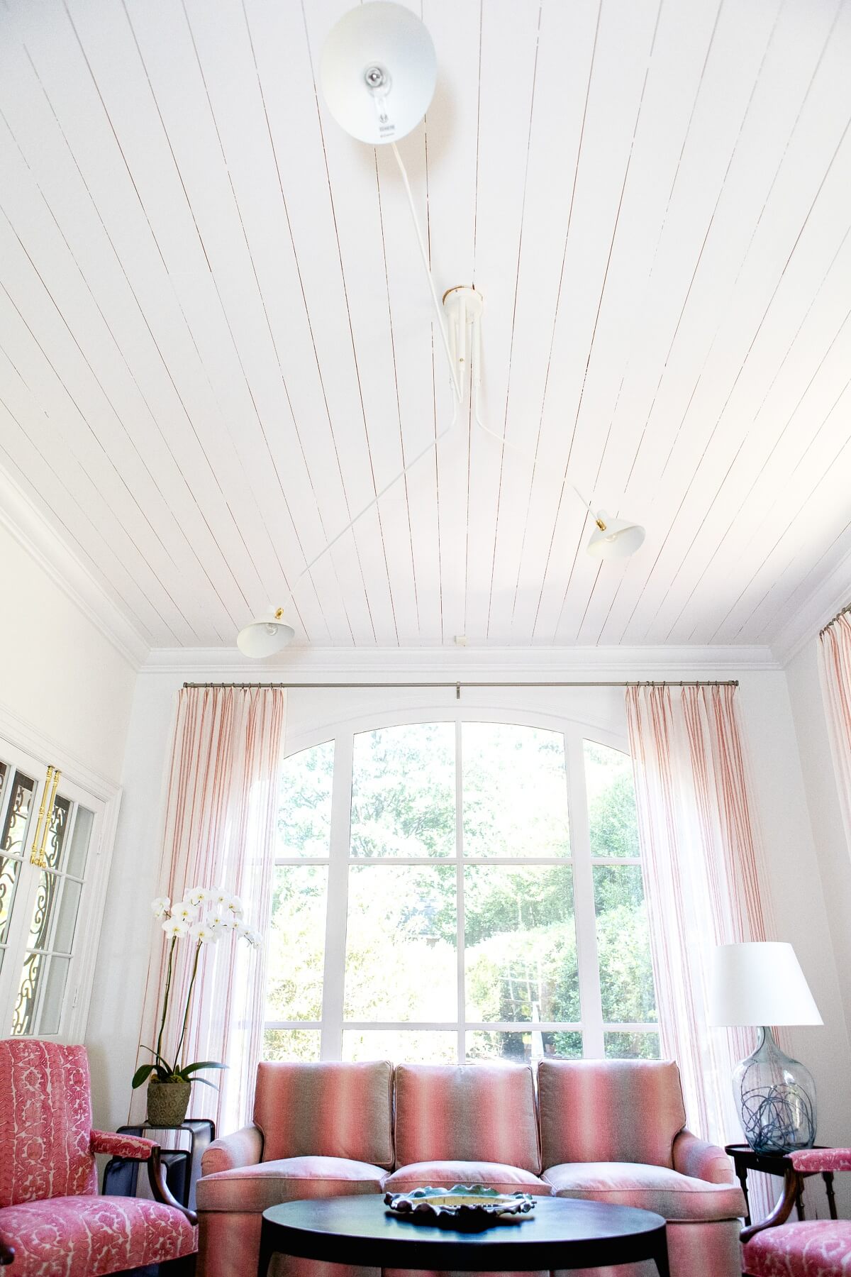 Natural light spills forth, reflecting off the white shiplap ceiling. Natural light spills forth, reflecting off the white shiplap ceiling.