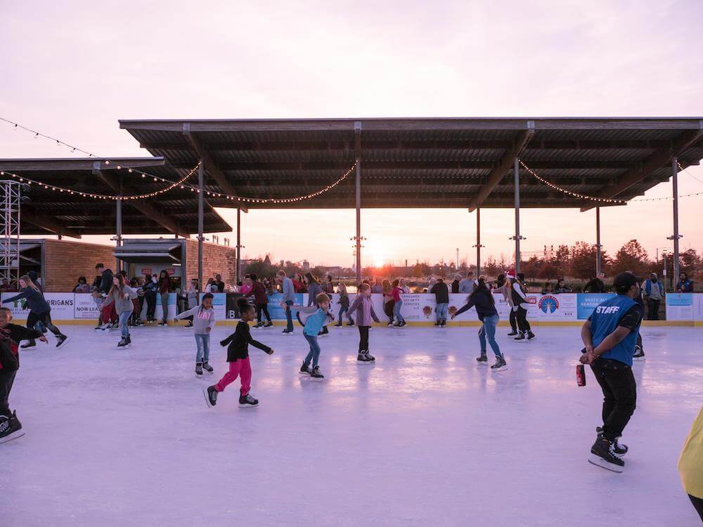 For visitors wanting a more traditional "White Christmas" experience, take them to the ice skating rink at Railroad Park! Image: Railroad Park