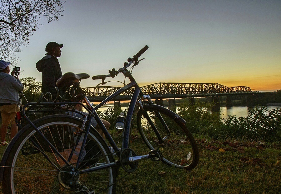 Cyclists pause to take in the sunset over the Mighty Mississippi near Big River Crossing.