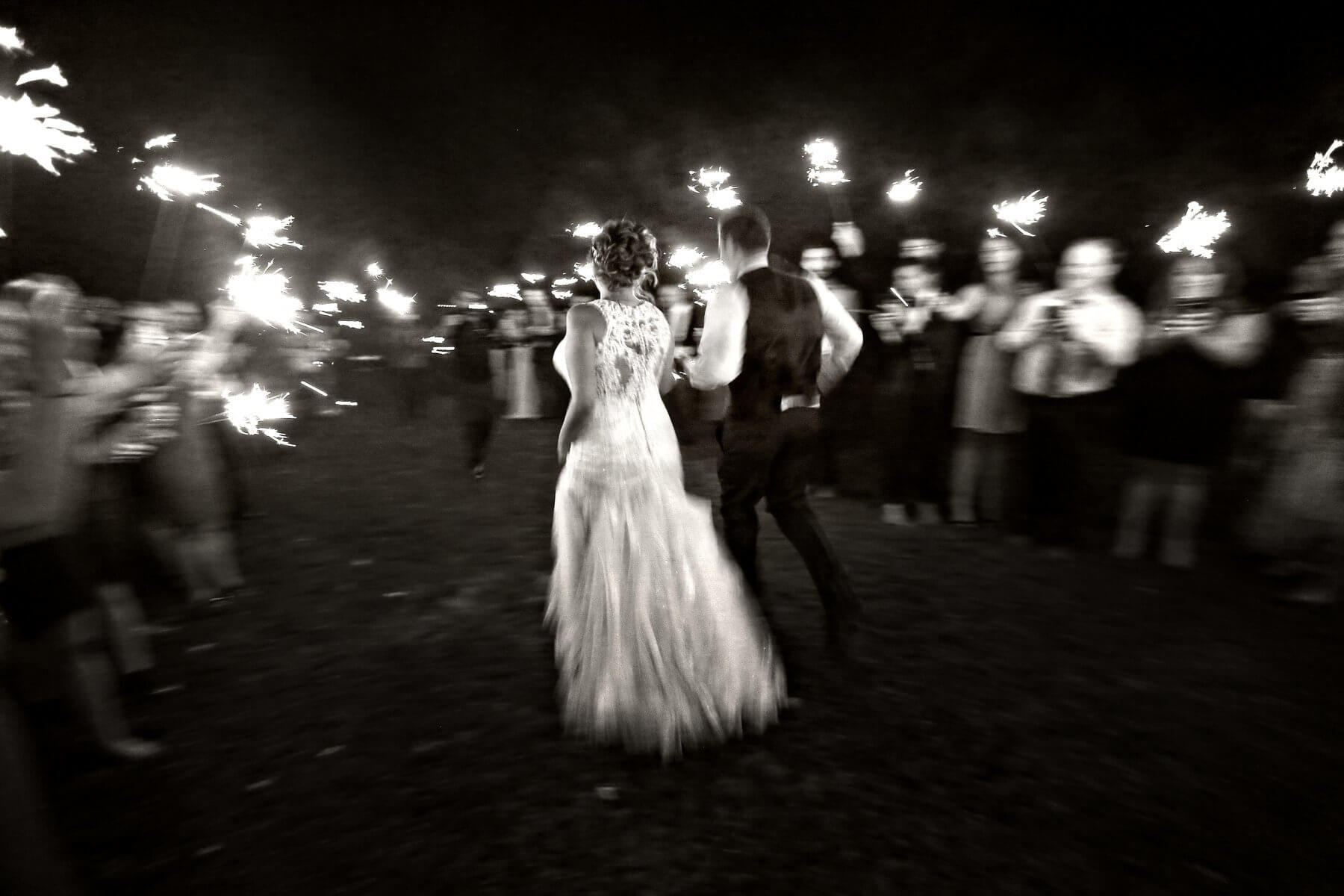 Mr. and Mrs. Cheatham run through a sparkler sendoff, laughing and beaming after their beautiful wedding day shared with family and friends. Richwood on the River