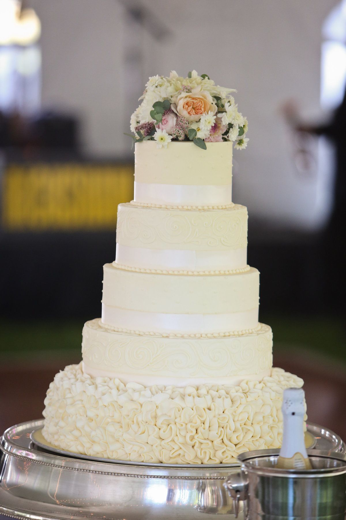 Out of all the details of this gorgeous wedding with so many special touches, Megan says settling on the cake was the most difficult decision. Christian loves chocolate cake while Megan prefers white, but they wanted each classic flavor to be delicious and stand on its own. The Bonbonerie created a traditional, elegant cake that satisfied both bride and groom. Richwood on the River