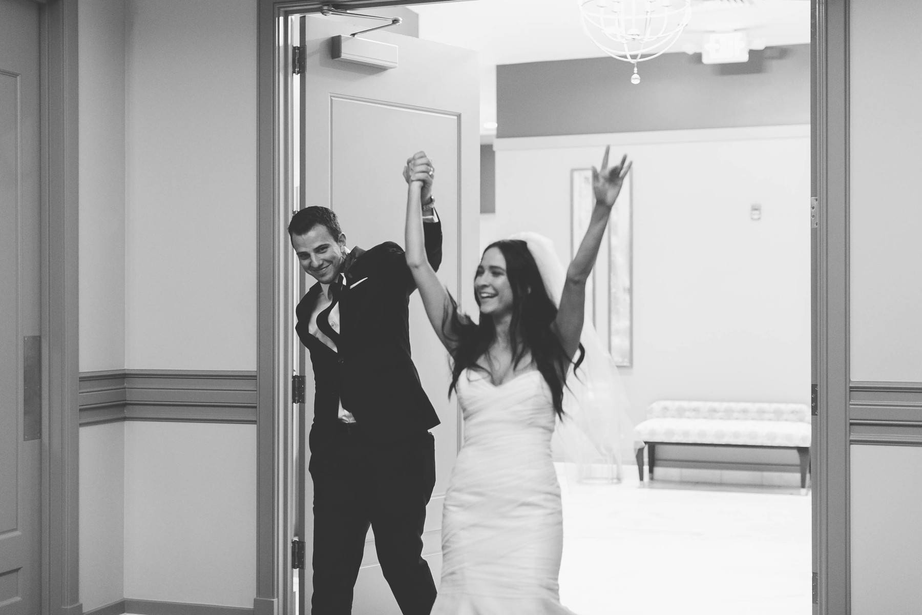 The happy couple triumphantly enters the reception.