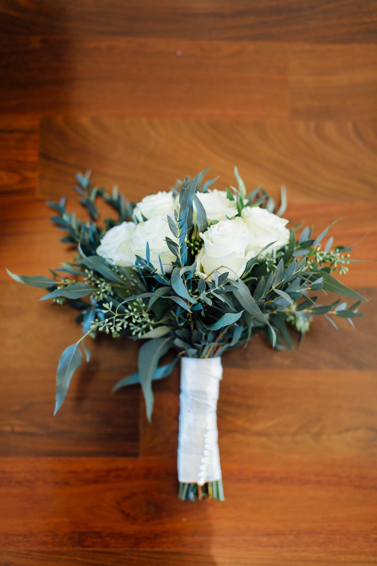 Taylor’s bouquet of white roses and greenery was simple and elegant. Whole Foods Market helped her with the arrangements.