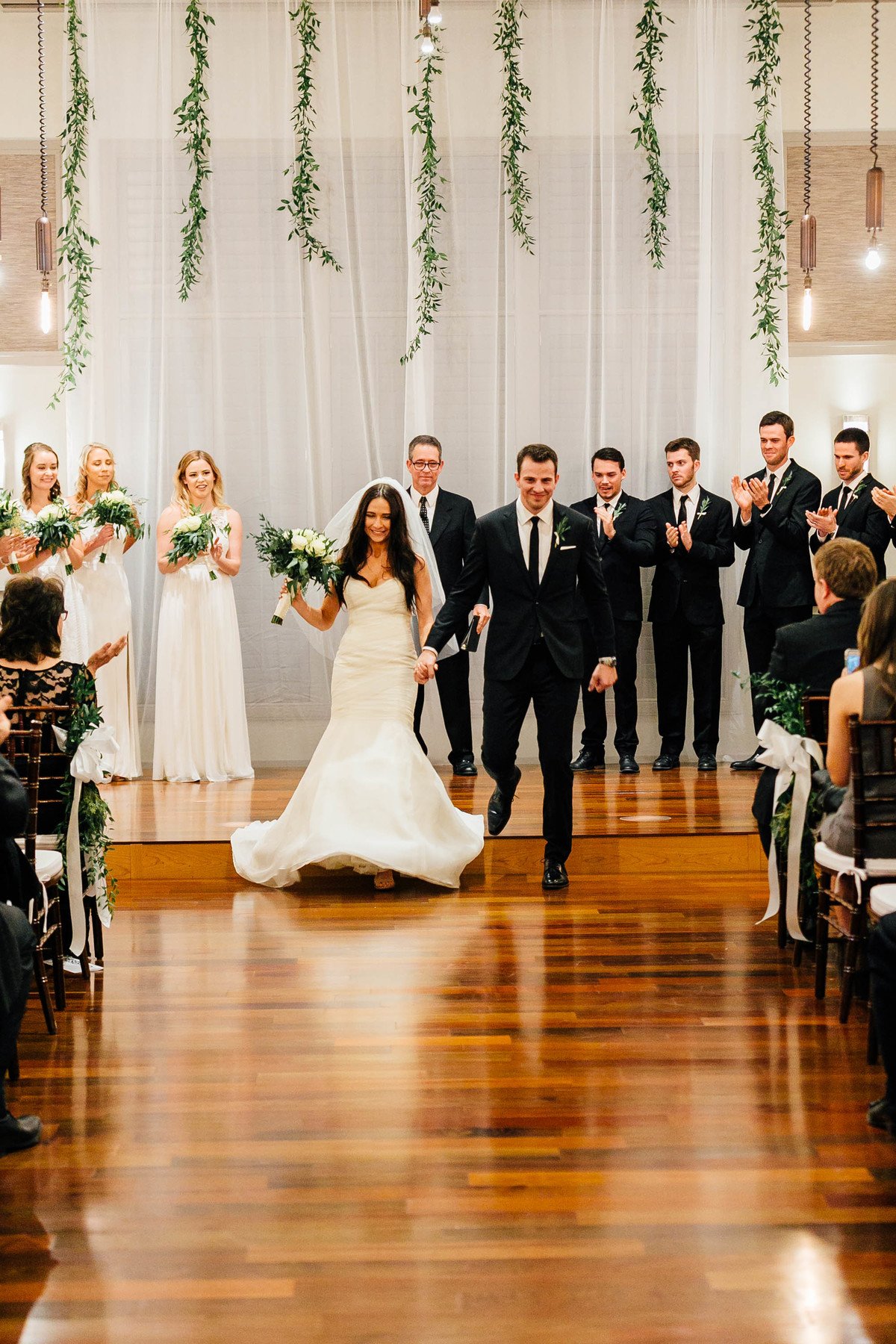 Taylor and Josh walk hand in hand back down the aisle as Mr. & Mrs. Kottke!