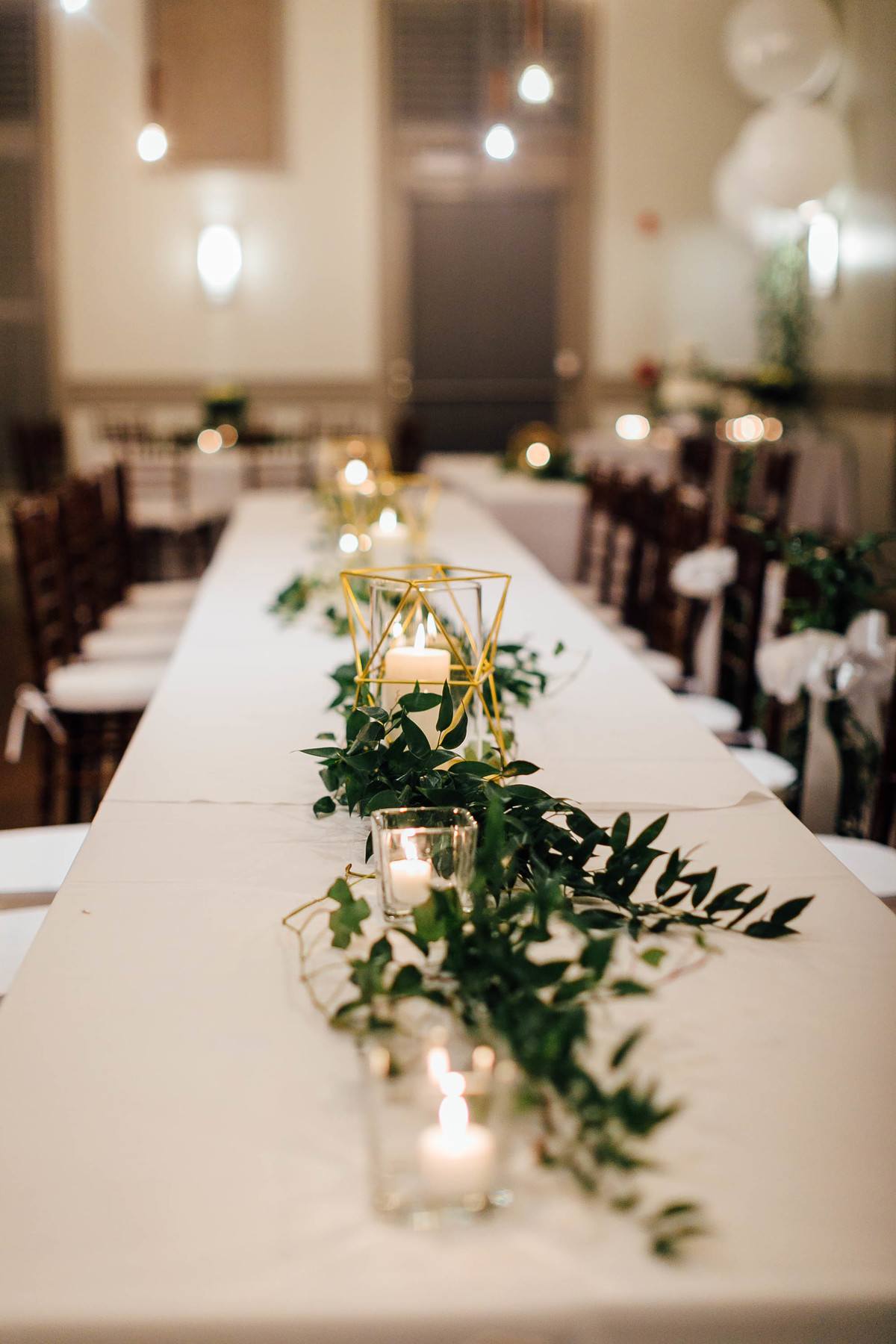 “For the flowers, I chose lots of greenery, like eucalyptus and little pretty vines, with white roses to match the dresses. I paired that with gold accents and candlelight,” explains Taylor.