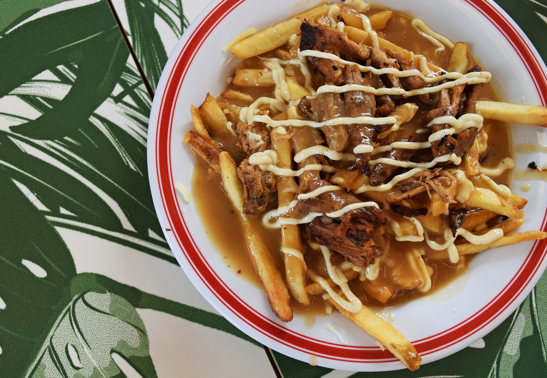 The loaded fries include Cuban pork, cheese and savory gravy, piled atop a mound of crispy fries. The Liquor Store