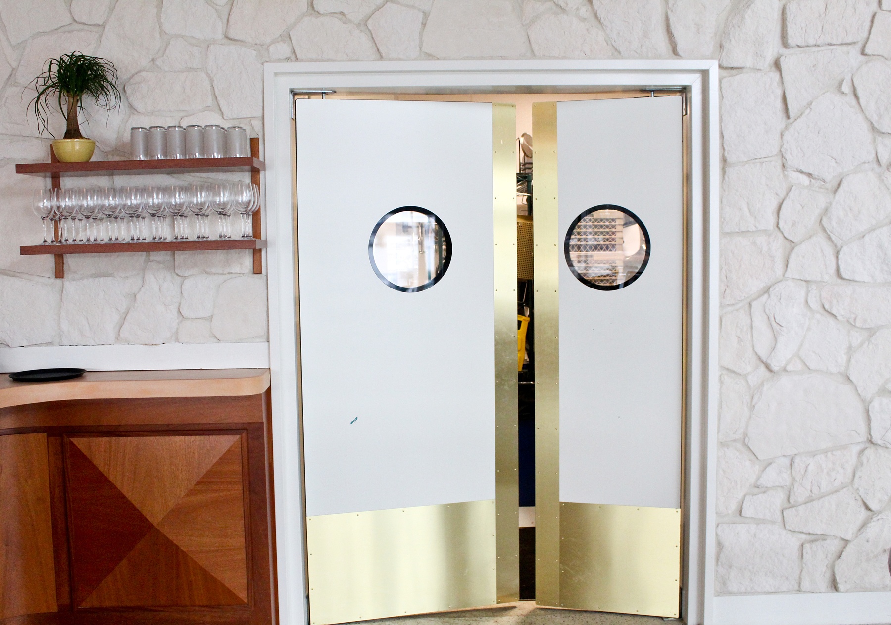 Swinging doors adjacent to the bar provide a peek to a busy kitchen. Hello, Sailor in Charlotte