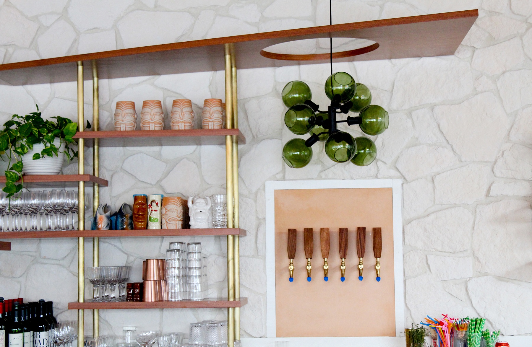 Note the shelves lined with tiki-inspired pottery, adding flavor to the bar backdrop. Hello, Sailor in Charlotte