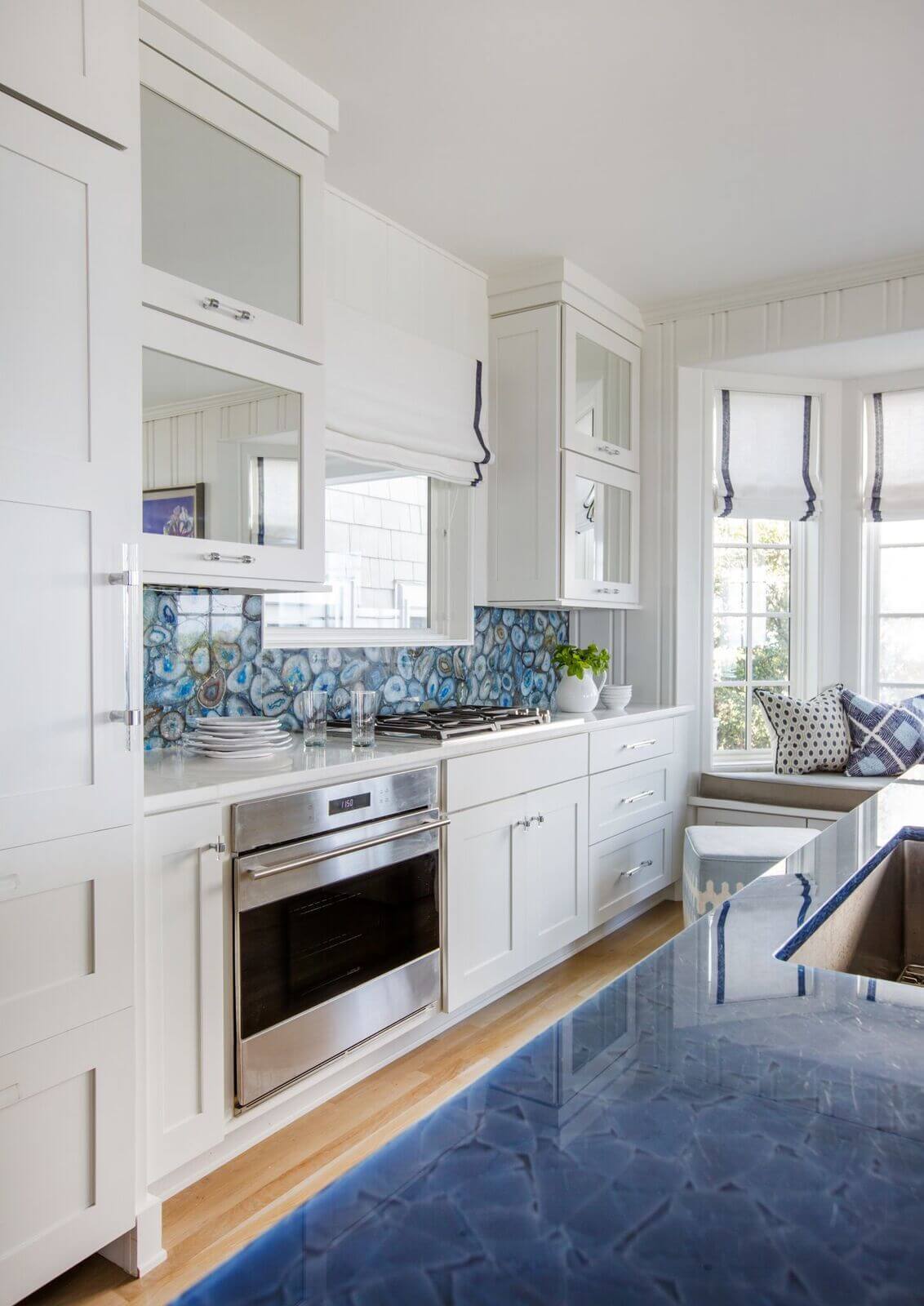 The use of natural blue agate for a backsplash gives the wall an artistic look. Ponte Vedra kitchen