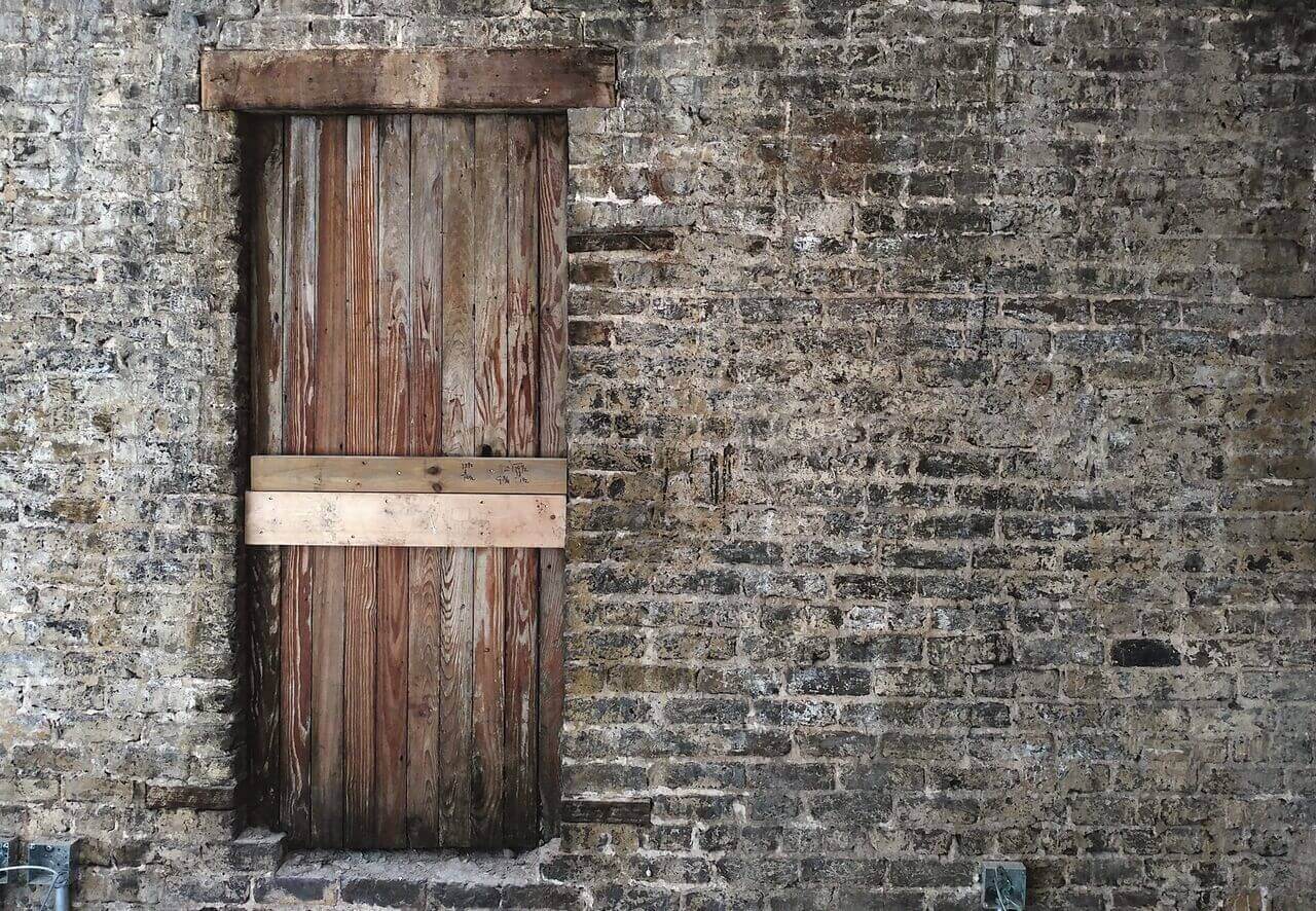 In one loft space, along a wall of timeworn brick, this boarded up window will keep some of the aged wood, but will be turned into a built-in shelving unit. The Thomas