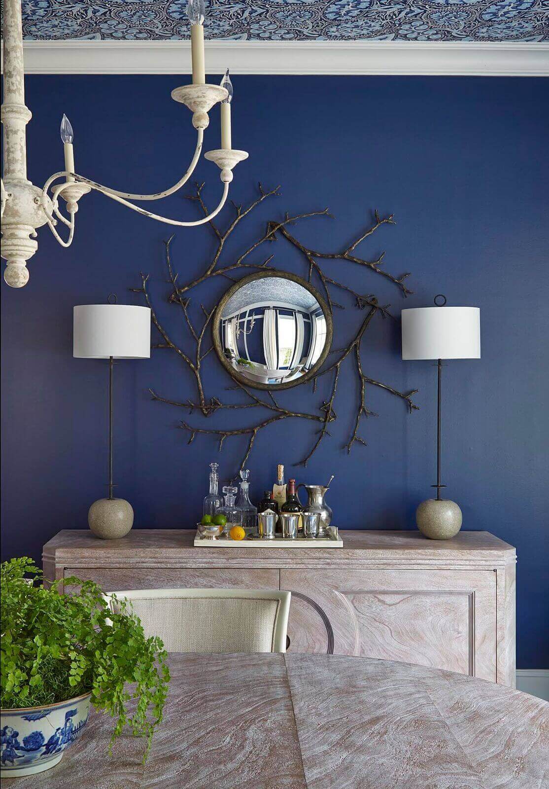 “I think dining rooms often have too much furniture in them,” says JoAnn. “I like having a console to serve food and drinks and offer a place for additional lighting but aside from a table and chairs, it should be all about comfort and company.” Table and console are from https://theodorealexander.com.
